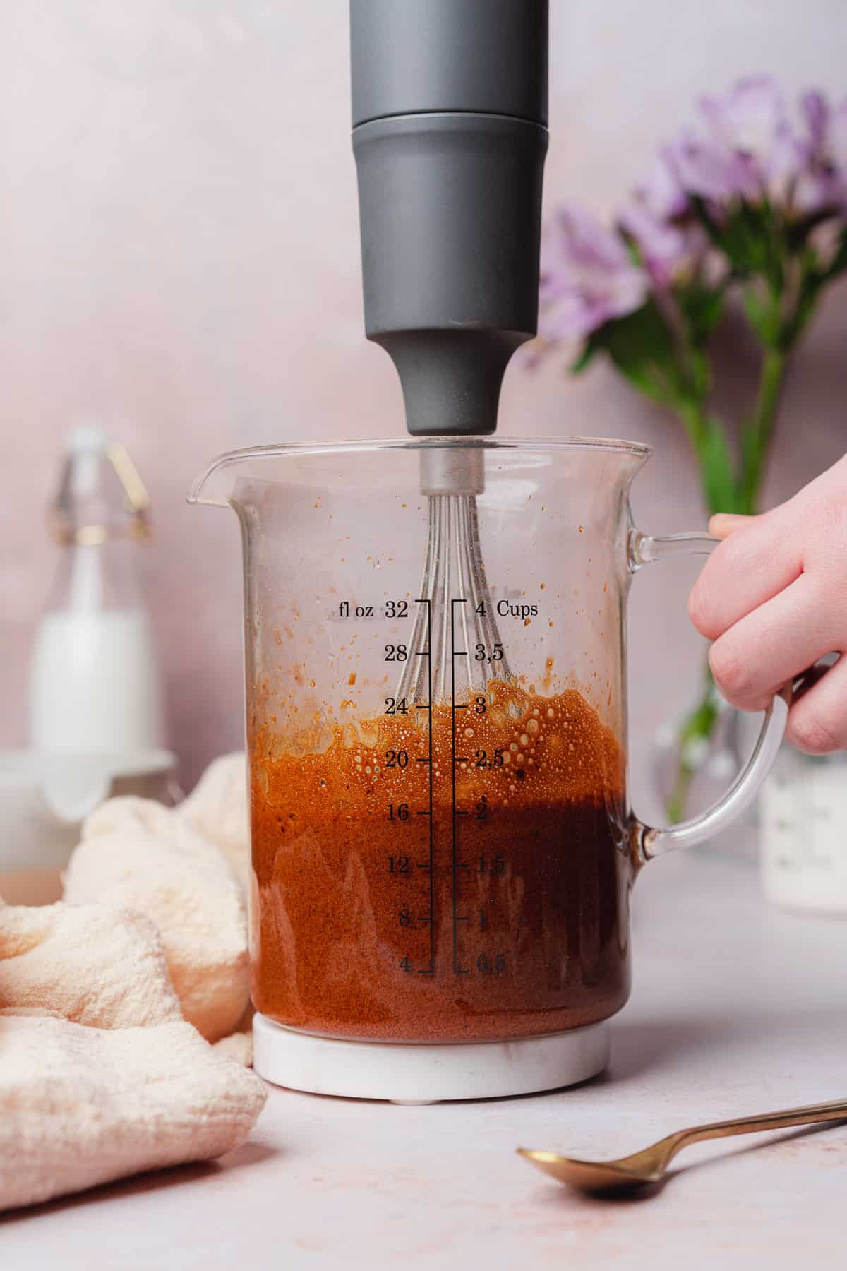 whisking together hot water and instant coffee mixture