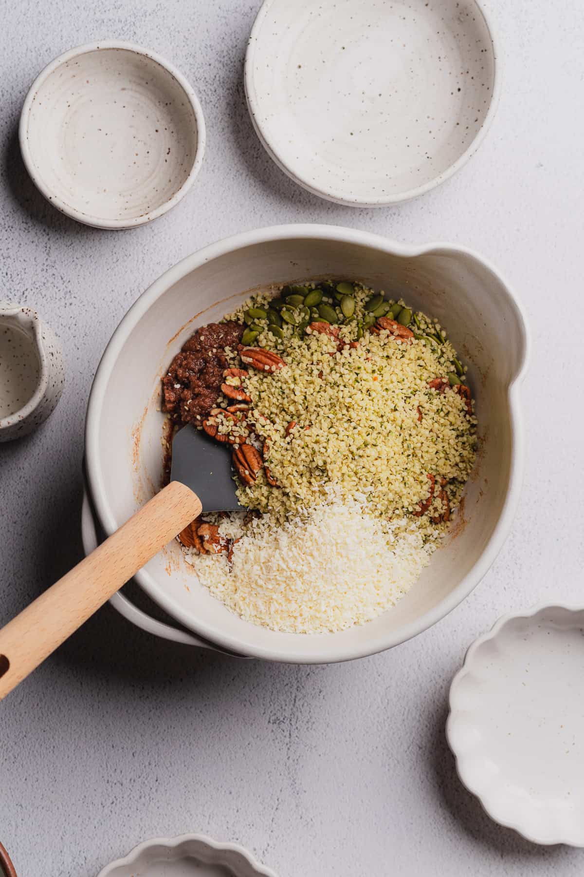 hemp hearts, nuts, pepitas and coconut flakes in a large bowl