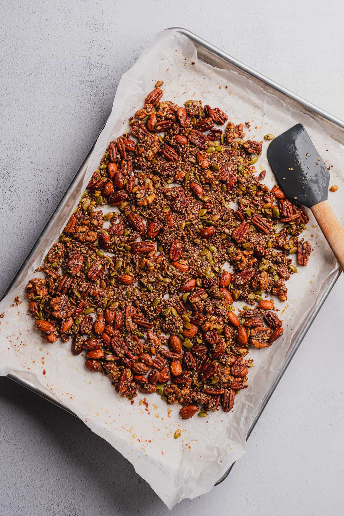 baking keto granola on a baking sheet with parchment. 