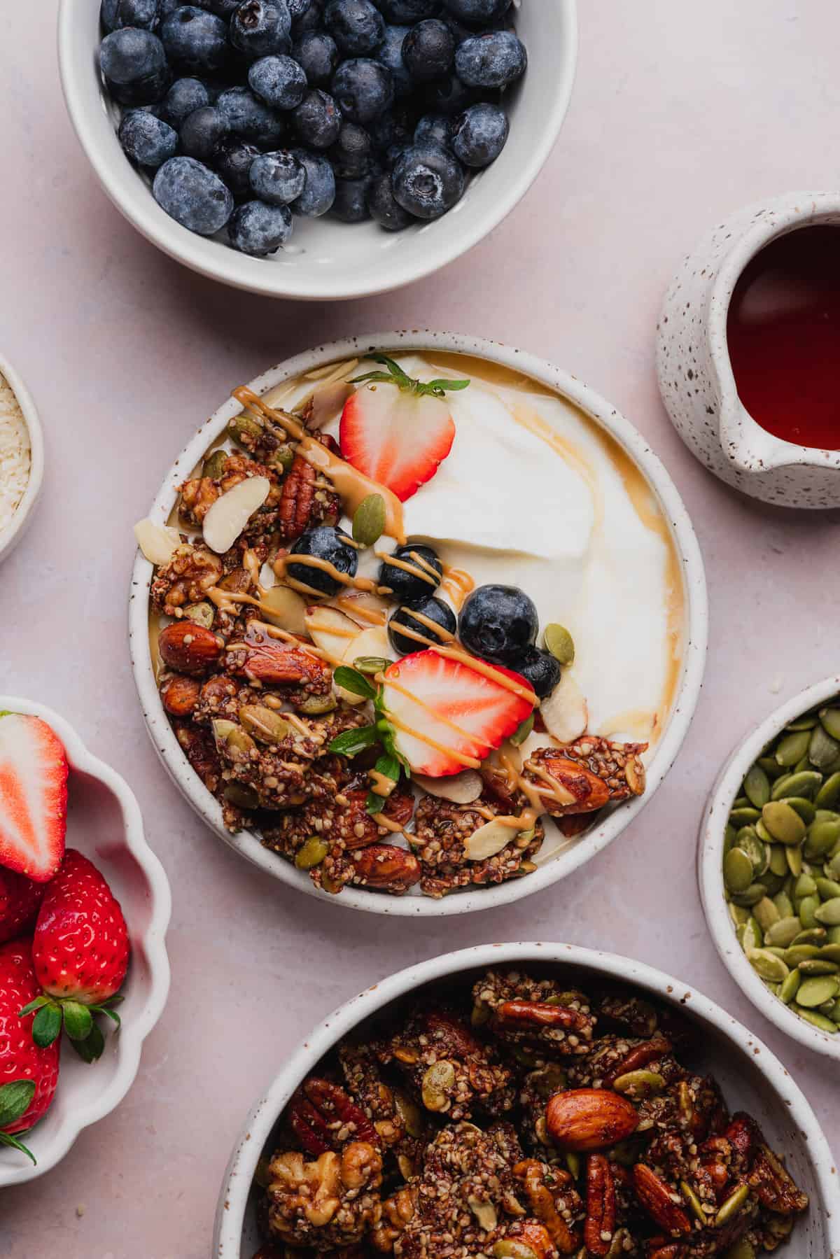 beautiful yogurt with granola and fruit bowl with melted chocolate, peanut butter, and maple syrup.
