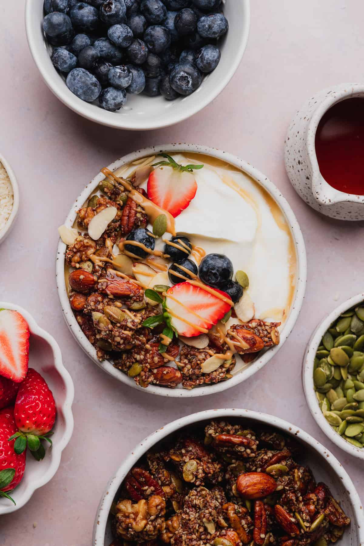 beautiful yogurt bowl with fresh fruit, melted chocolate and maple syrup. 