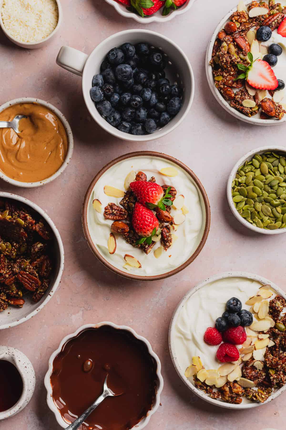 yogurt with granola and fresh strawberries, blueberries, and raspberries. 