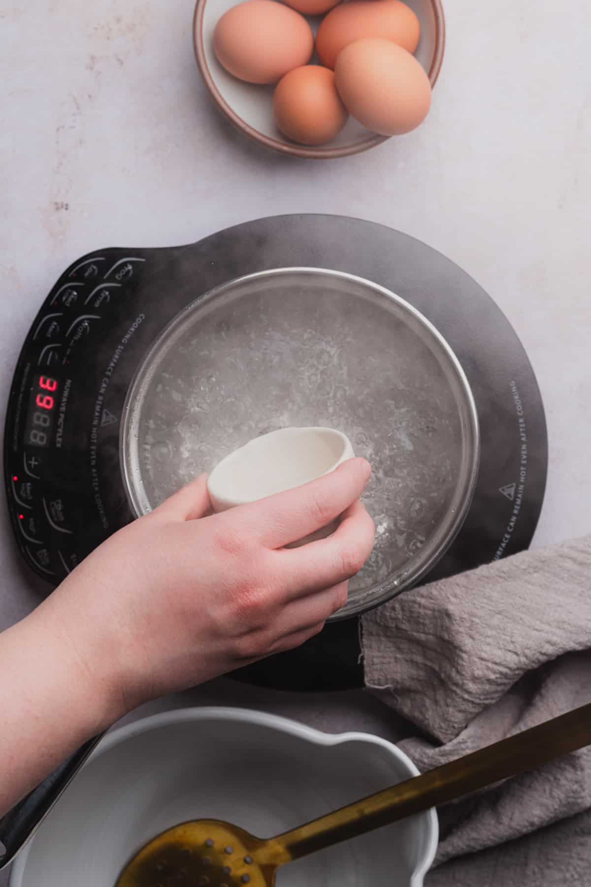 pouring vinegar into boiling water 