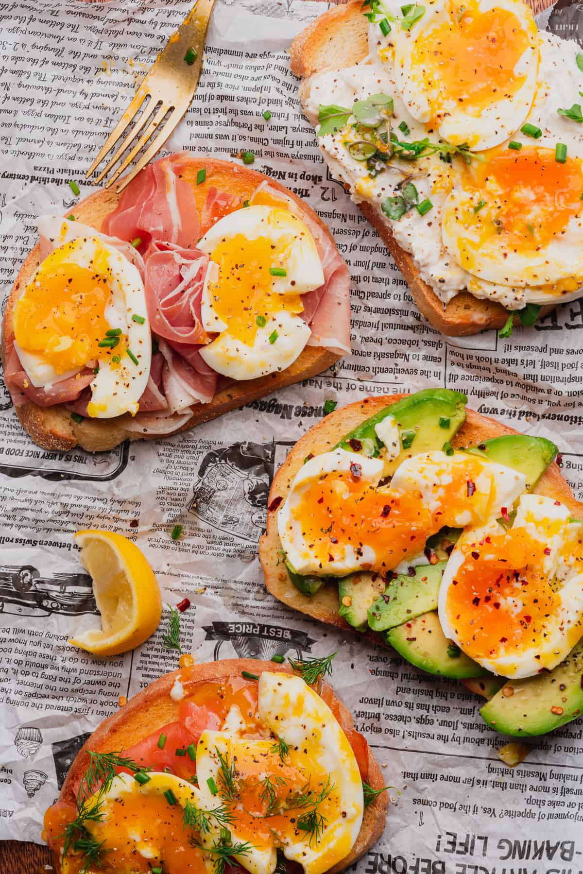 close up shot of various slices of toast topped with avocado, eggs, prosciutto, burrata and more 
