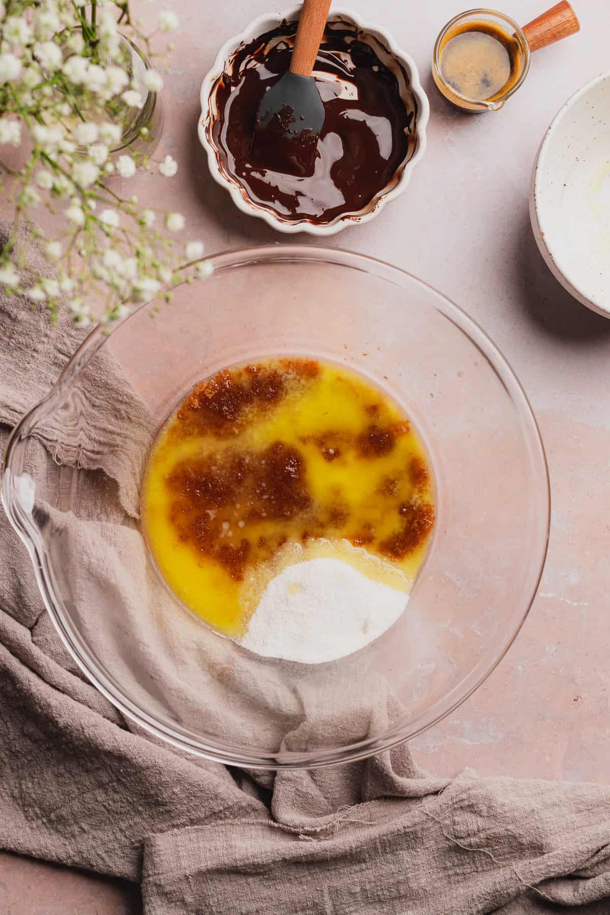 melted butter, white sweetener and brown sweetener in a glass bowl