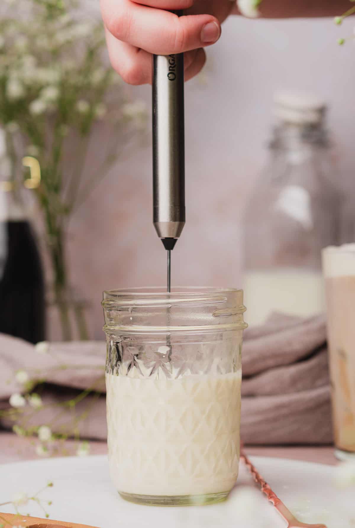 using a handheld frother to make vanilla sweet cream cold foam. 