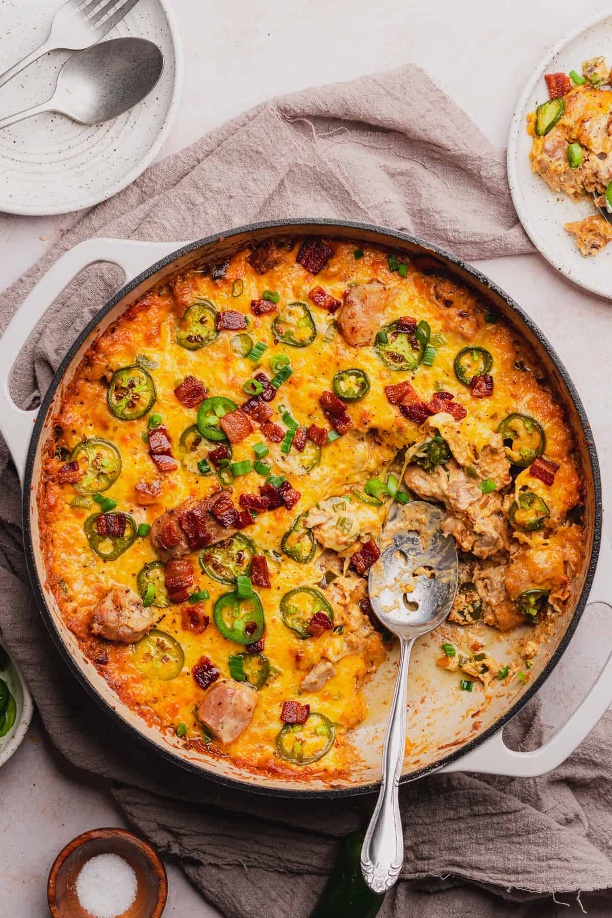spoon in an enameled dutch oven of jalapeno popper chicken skillet