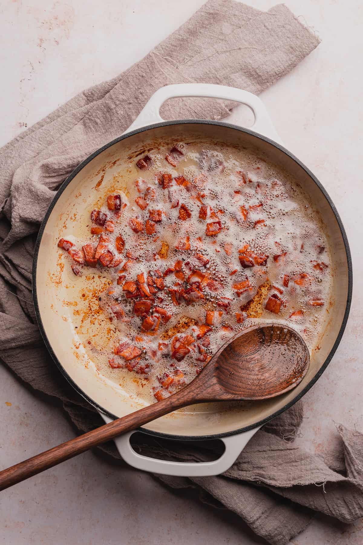 cooking bacon bits in an enameled dutch oven 