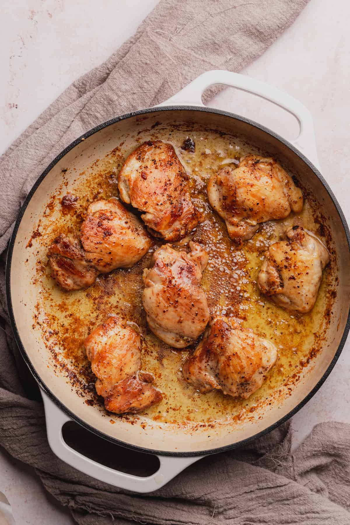 seared chicken thighs in an enameled dutch oven 