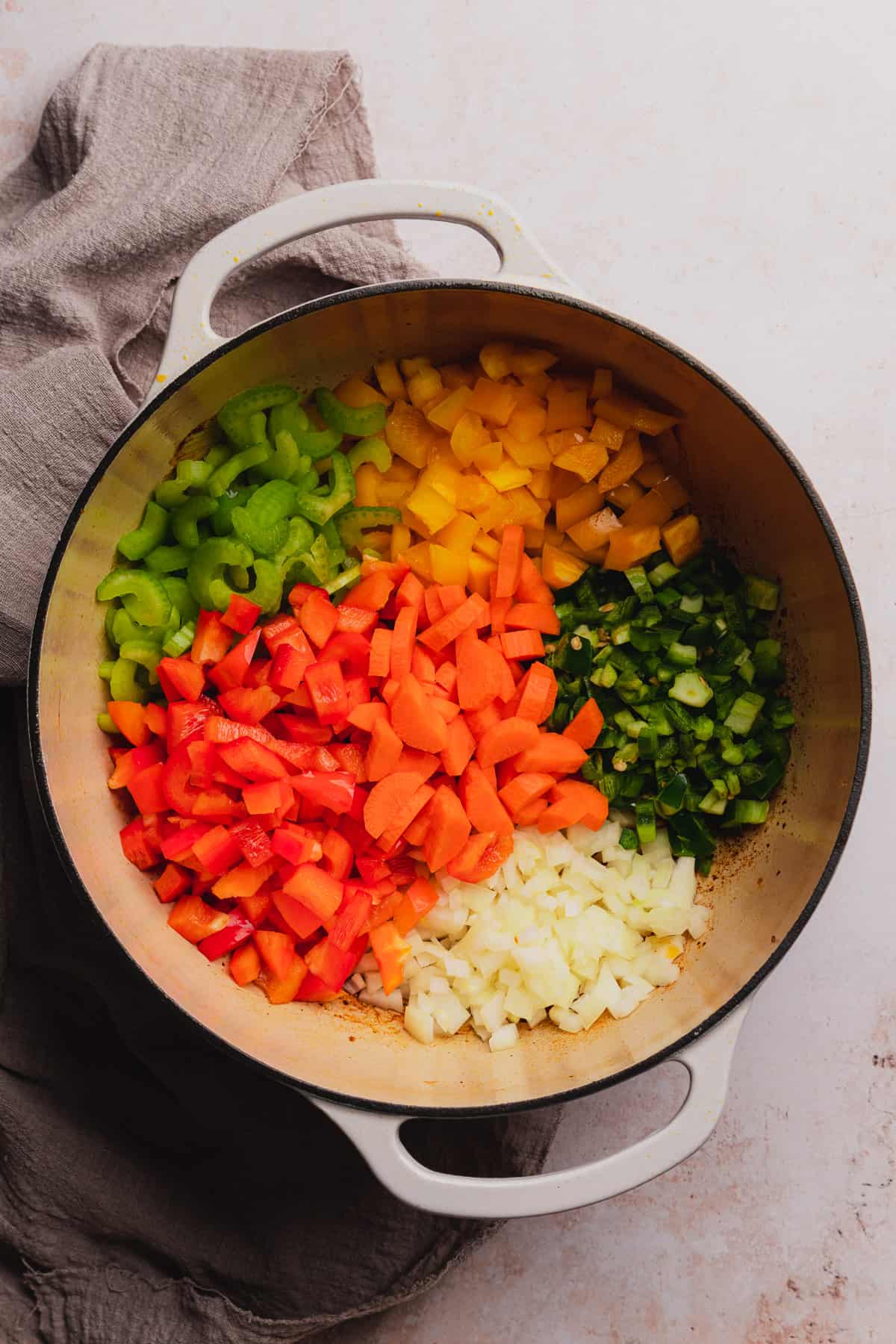 carrots, onion, jalapenos, bell peppers, and celery in a dutch oven