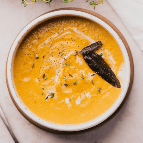 keto butternut squash soup with crispy fried sage drizzled with olive oil, fresh thyme, and heavy cream