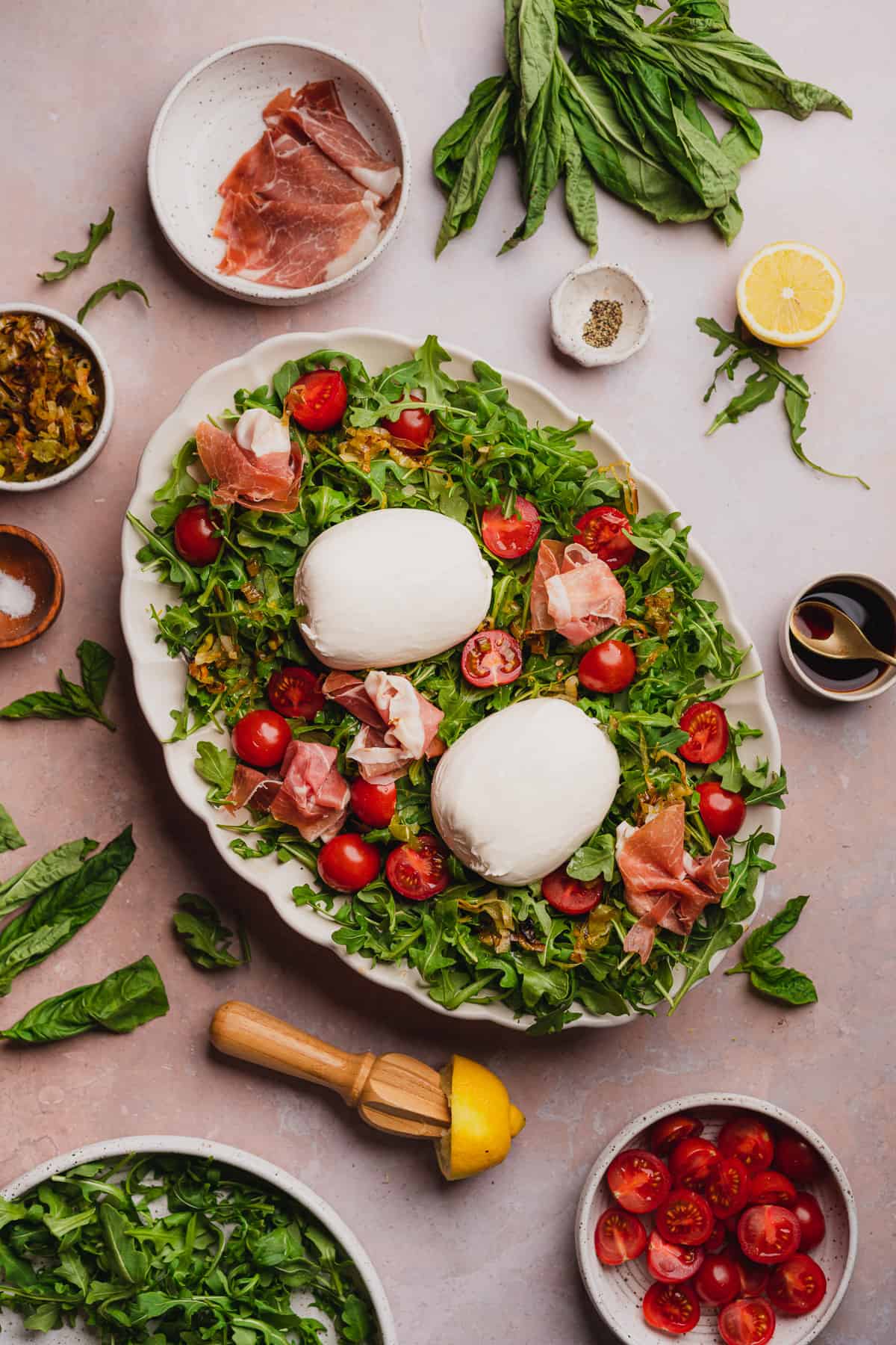 arugula salad with burrata and prosciutto, fried leeks, tomatoes, basil, lemon and balsamic vinegar.