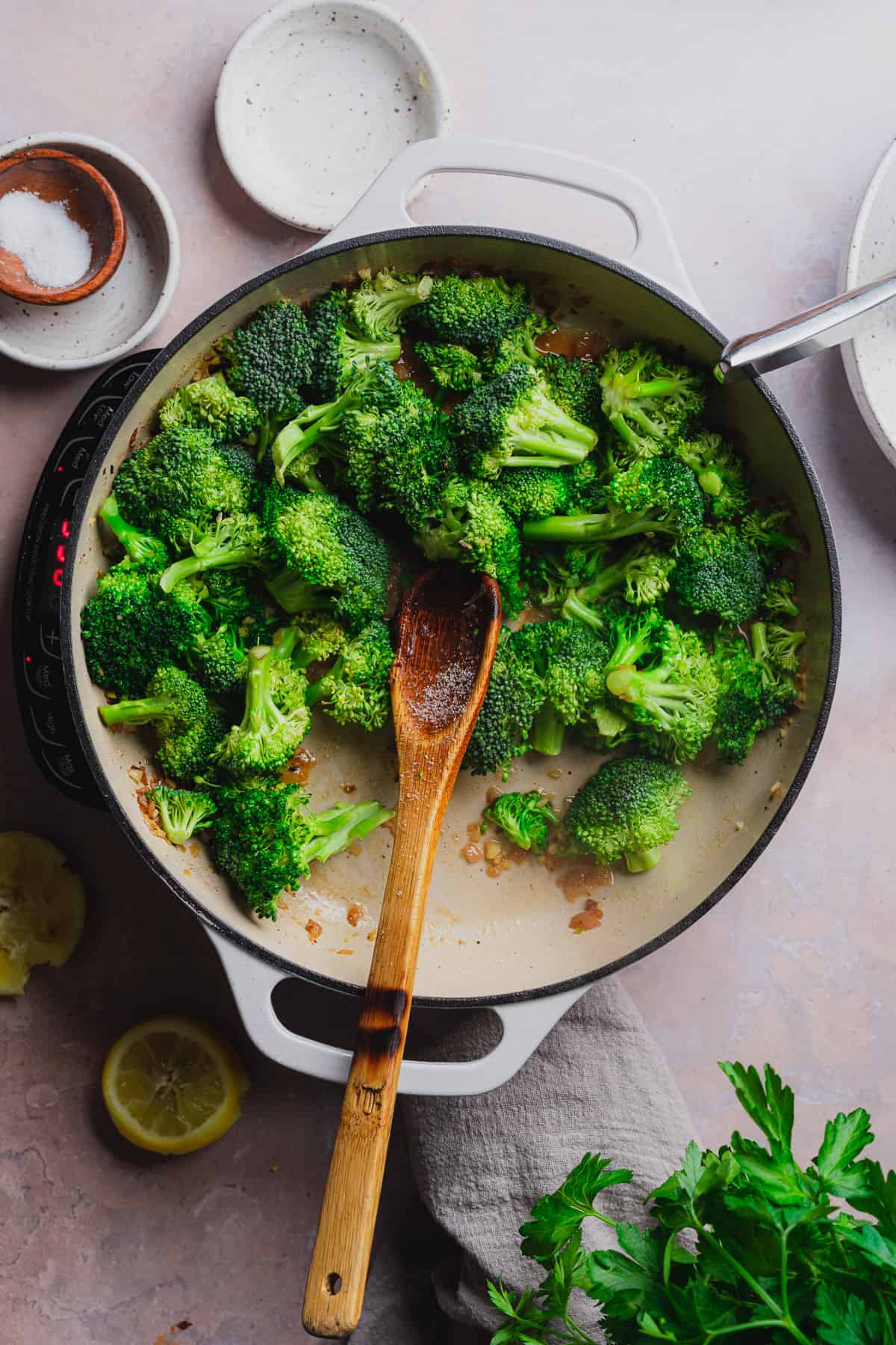 cooking broccoli in a skillet with seasonings. 