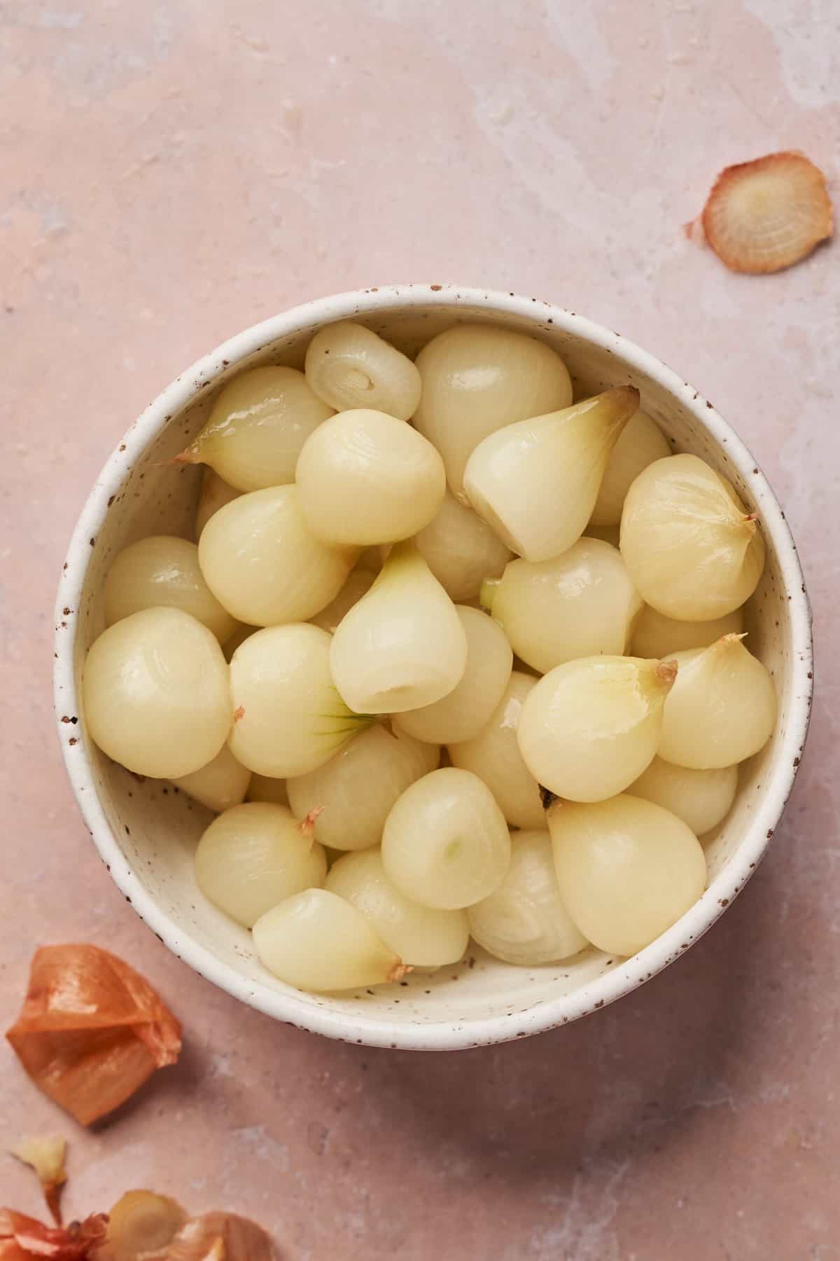 peeled pearl onions in a small dish.