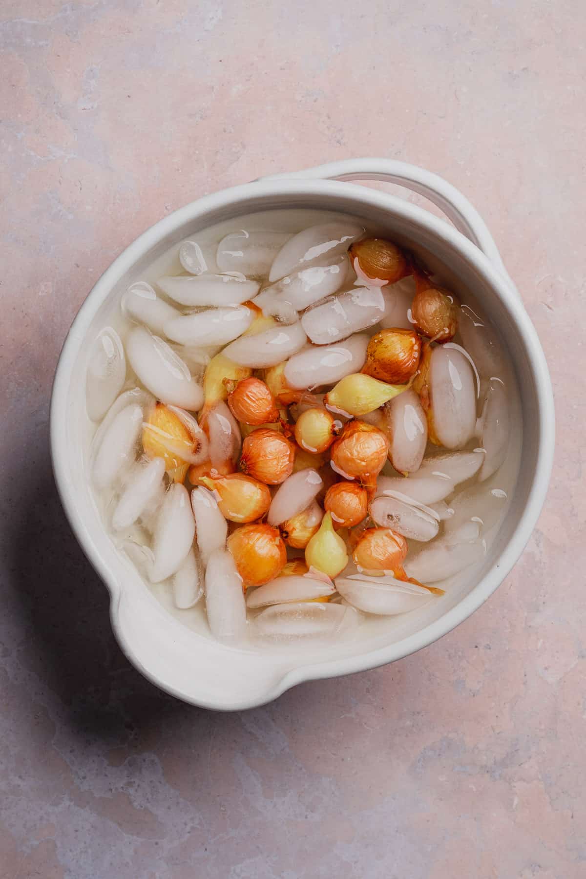 pearl onions in a bowl of ice water. 