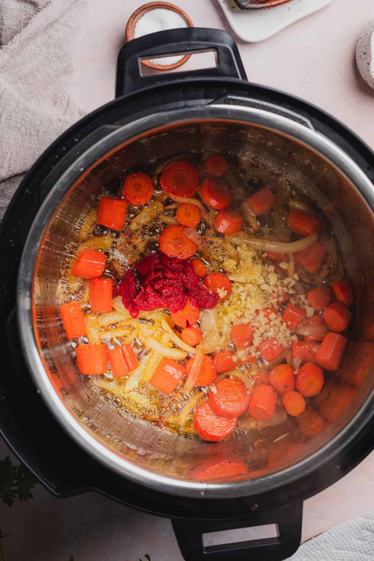 cooked onions and carrots in an instant pot with tomato paste and garlic. 