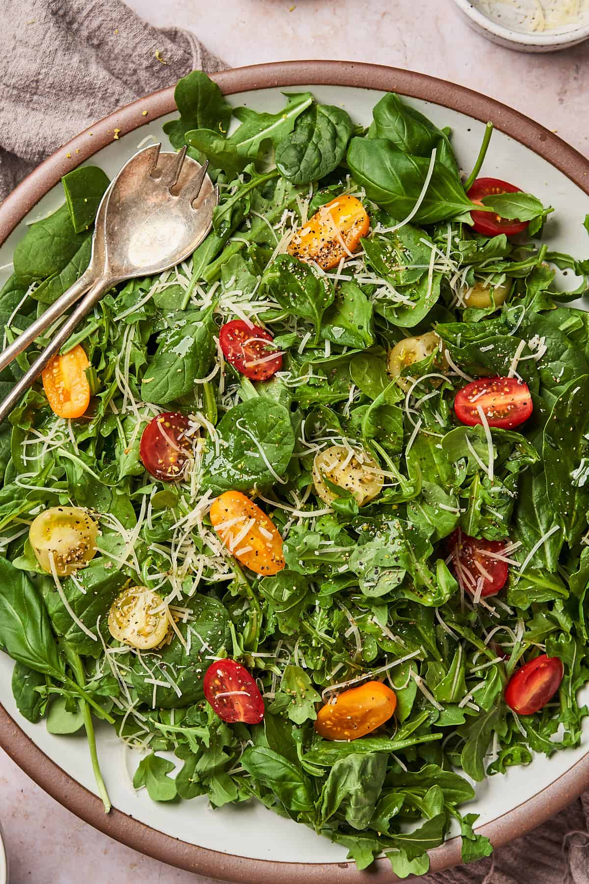 close up zoomed in shot of an arugula spinach salad with tomatoes