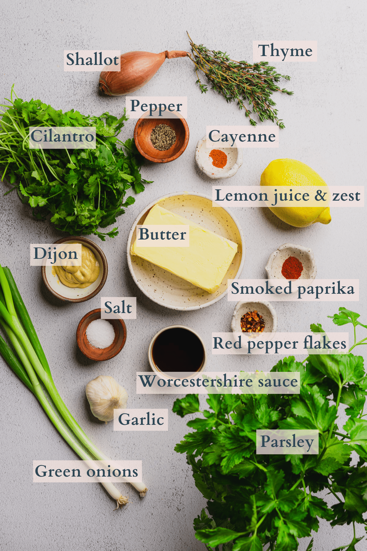 cowboy butter ingredients graphic with text to denote each ingredient including butter, parsley, cilantro, thyme, green onions, lemon, cayenne, pepper, salt, red pepper flakes, smoked paprika, Worcestershire sauce, garlic, shallot, and dijon mustard. 