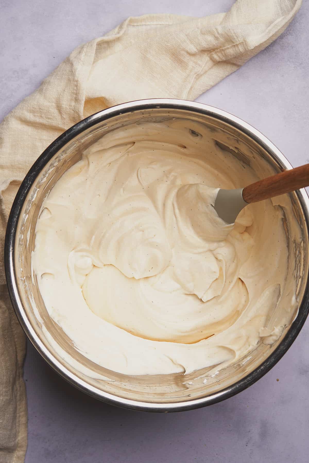 mixing sweetened condensed milk and whipped cream in a bowl. 