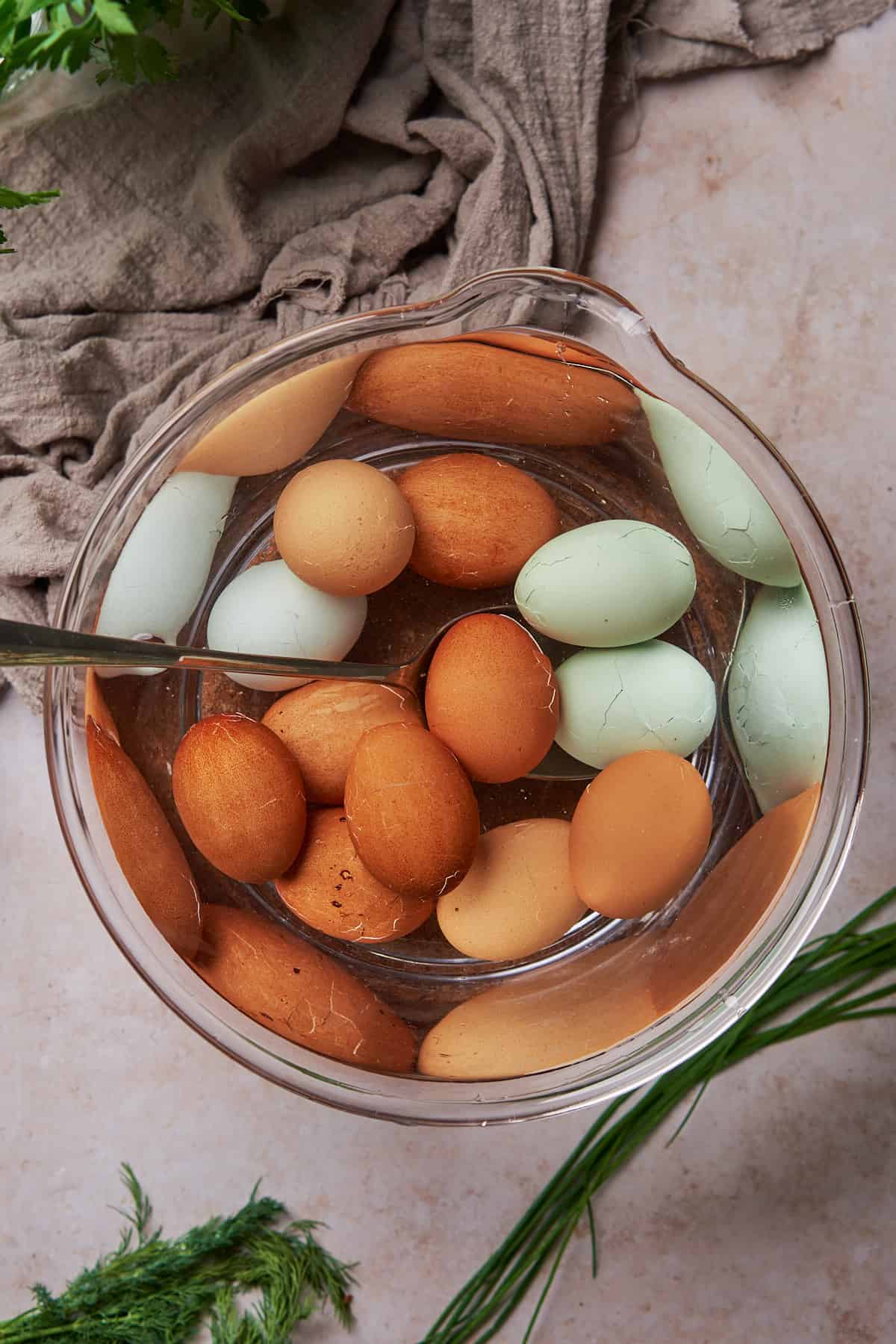blue and brown eggs in a bowl of cold water. 