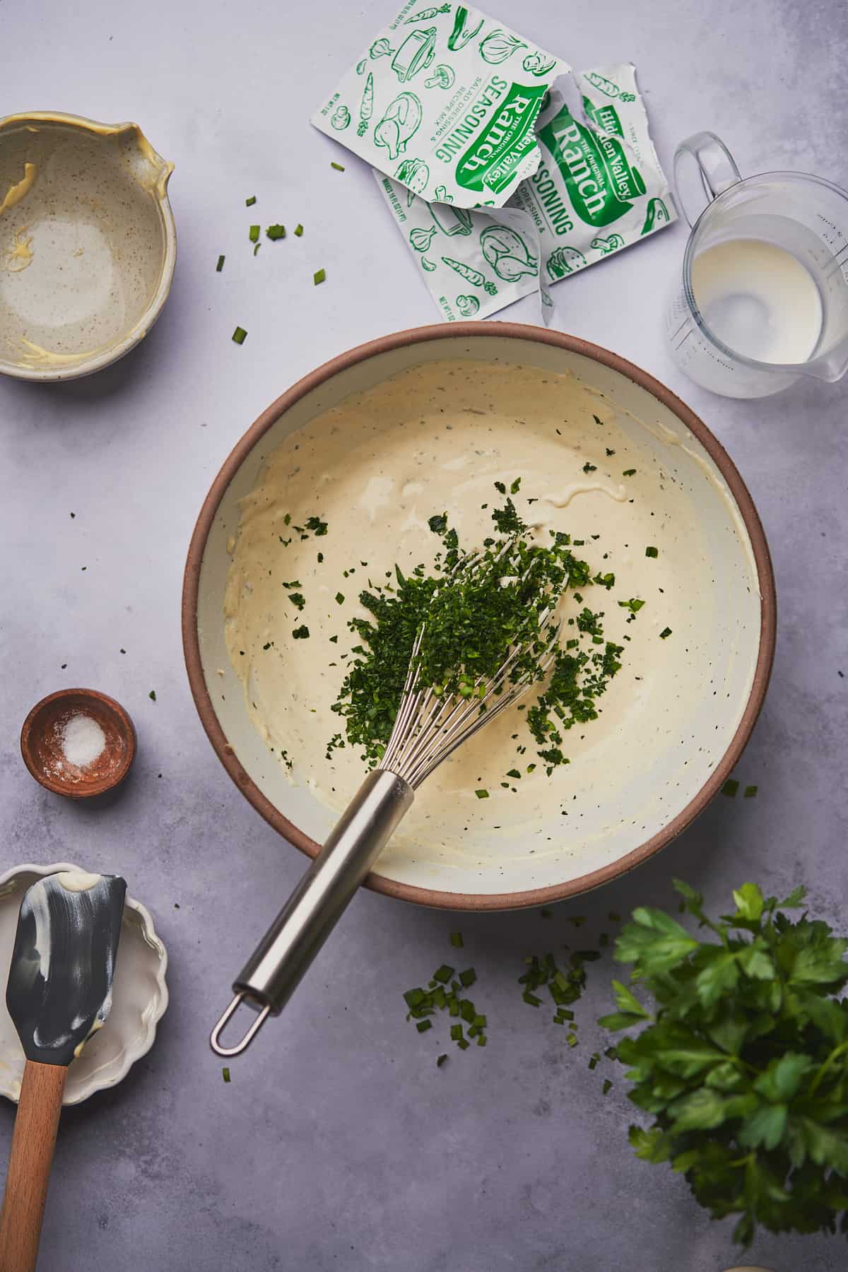 fresh parsley and chives in a large mixing bowl with a whisk. 