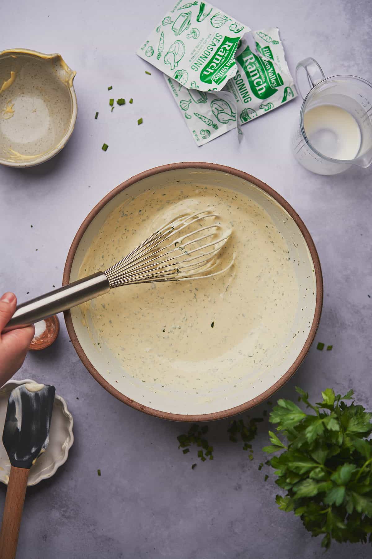 whisking together a wingstop ranch recipe in a large bowl. 