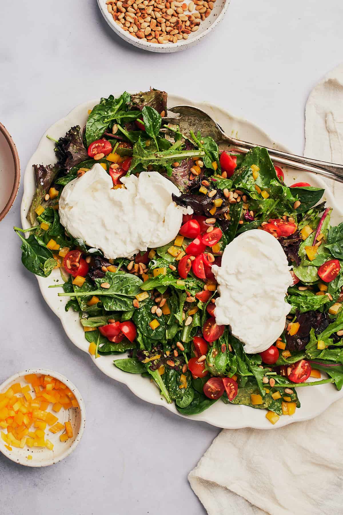 salad with creamy burrata cheese on top. 