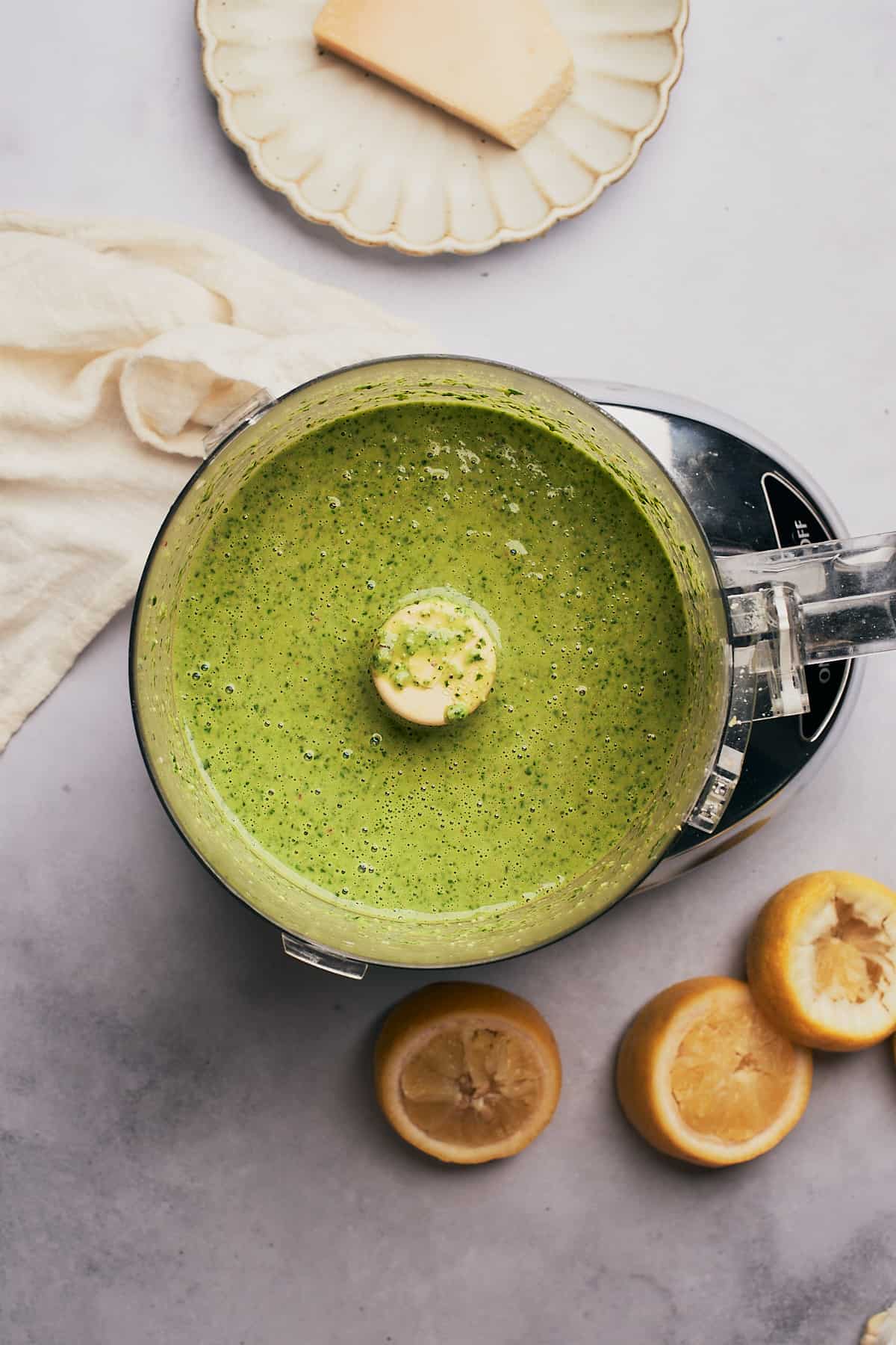 food processed pesto vinaigrette with lemon halves on the table. 