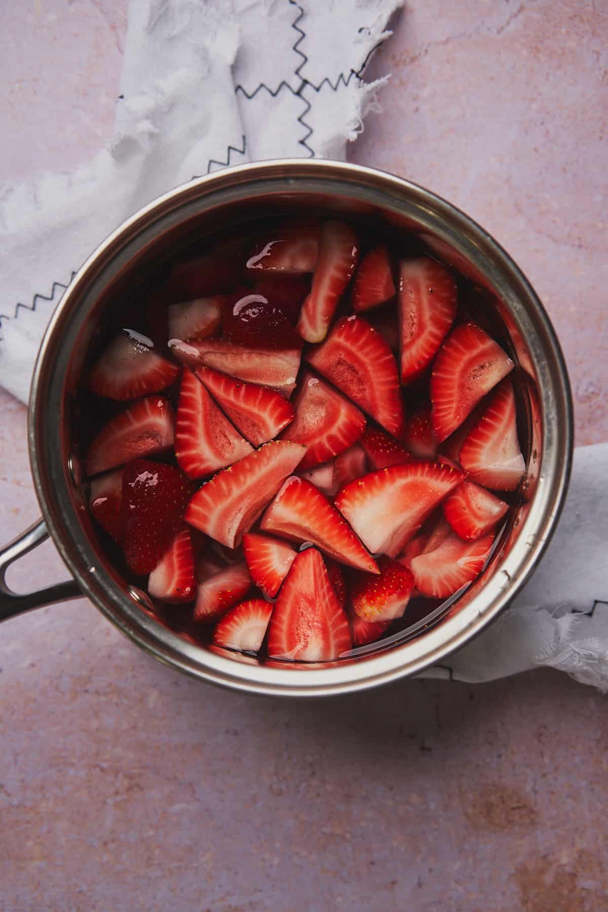 fresh strawberries in a saucepan with water.