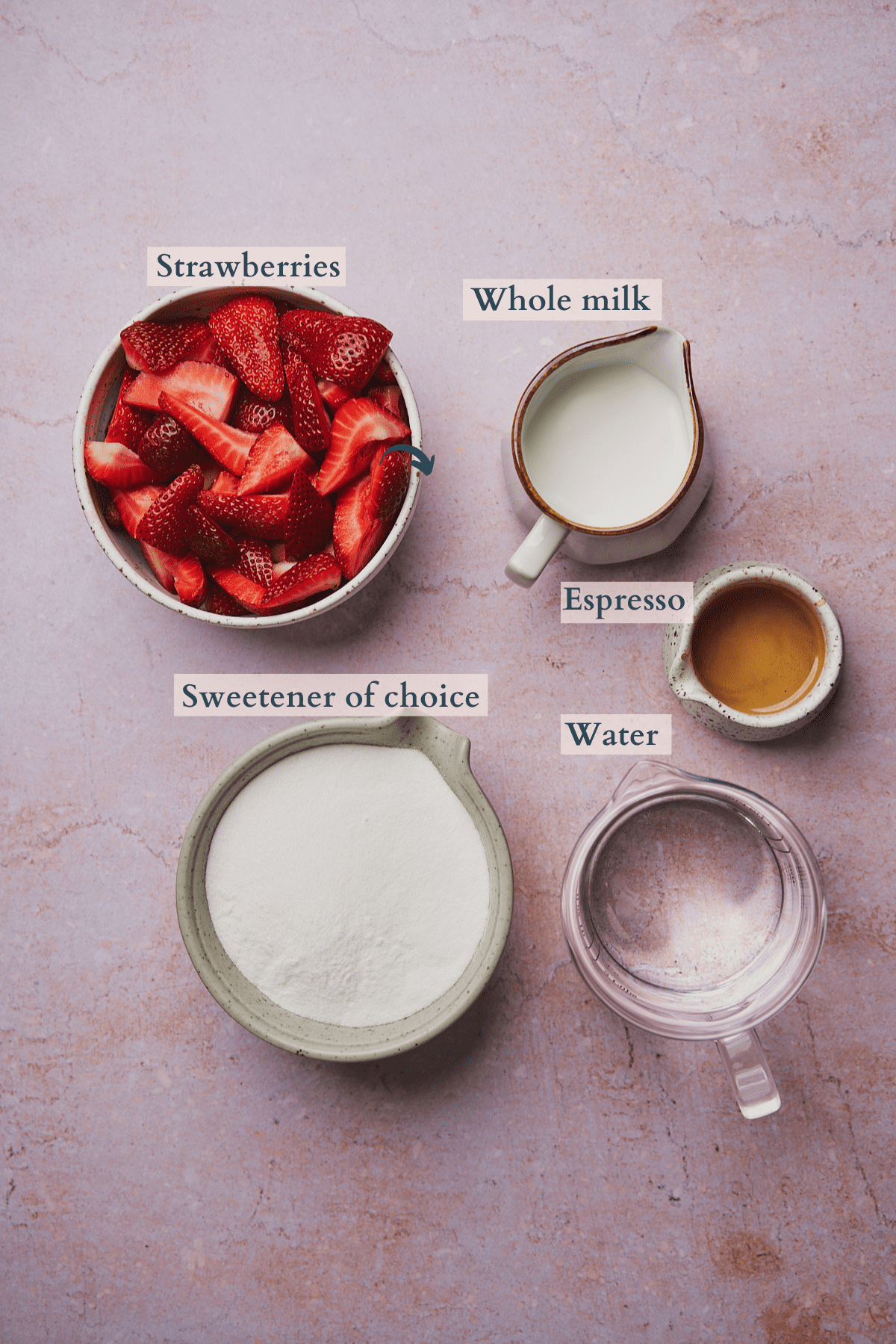 ingredients to make a strawberry latte with milk, sweetener, strawberries, water and espresso. 