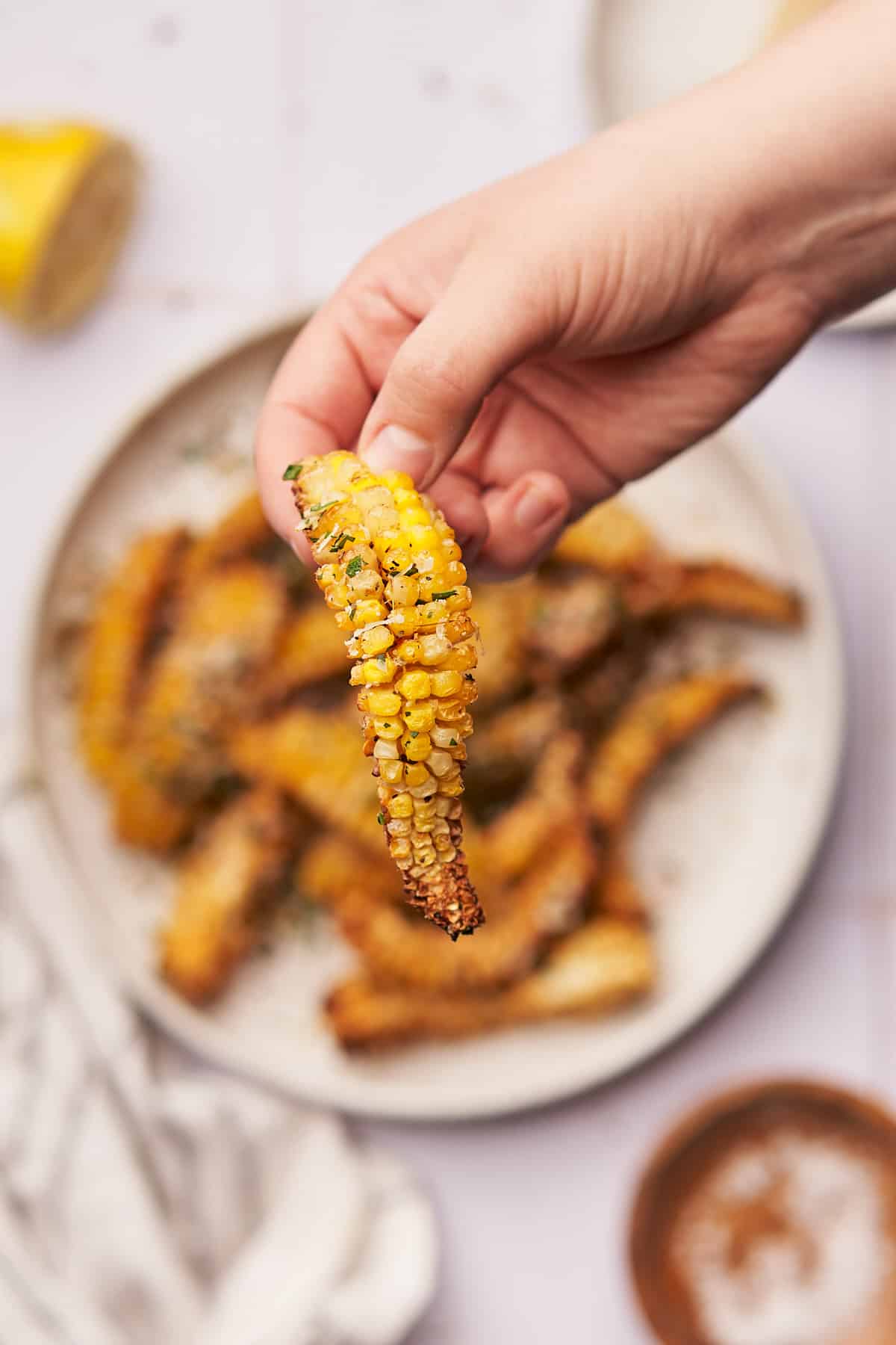 hand holding a bending corn rib up to the camera.
