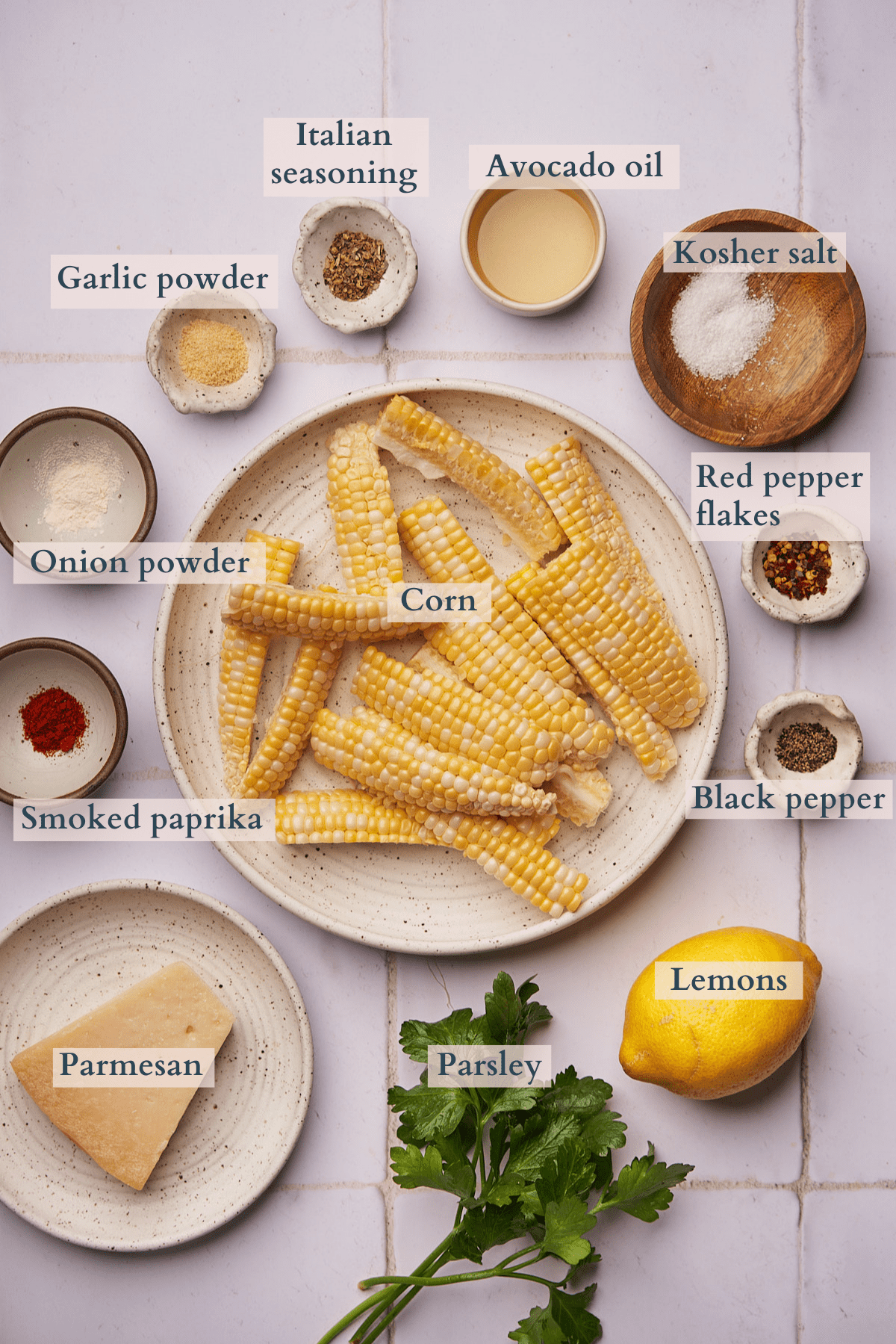 ingredients to make corn ribs, set out in small ceramic containers with text to denote each ingredient. 