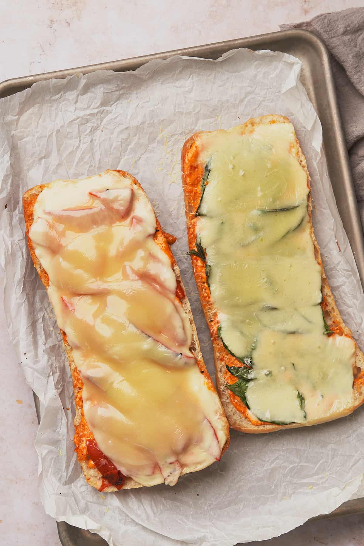 italian grinder sub with melted cheese over top of the bread. 