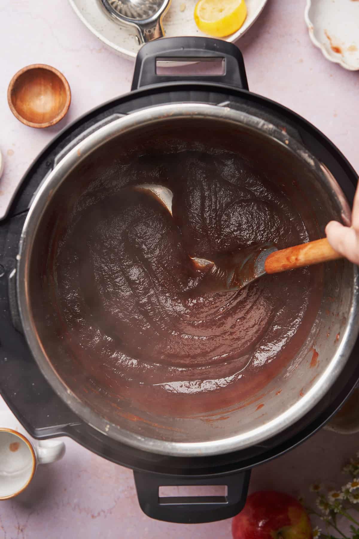 stirring the apple butter in an instant pot as it thickens. 