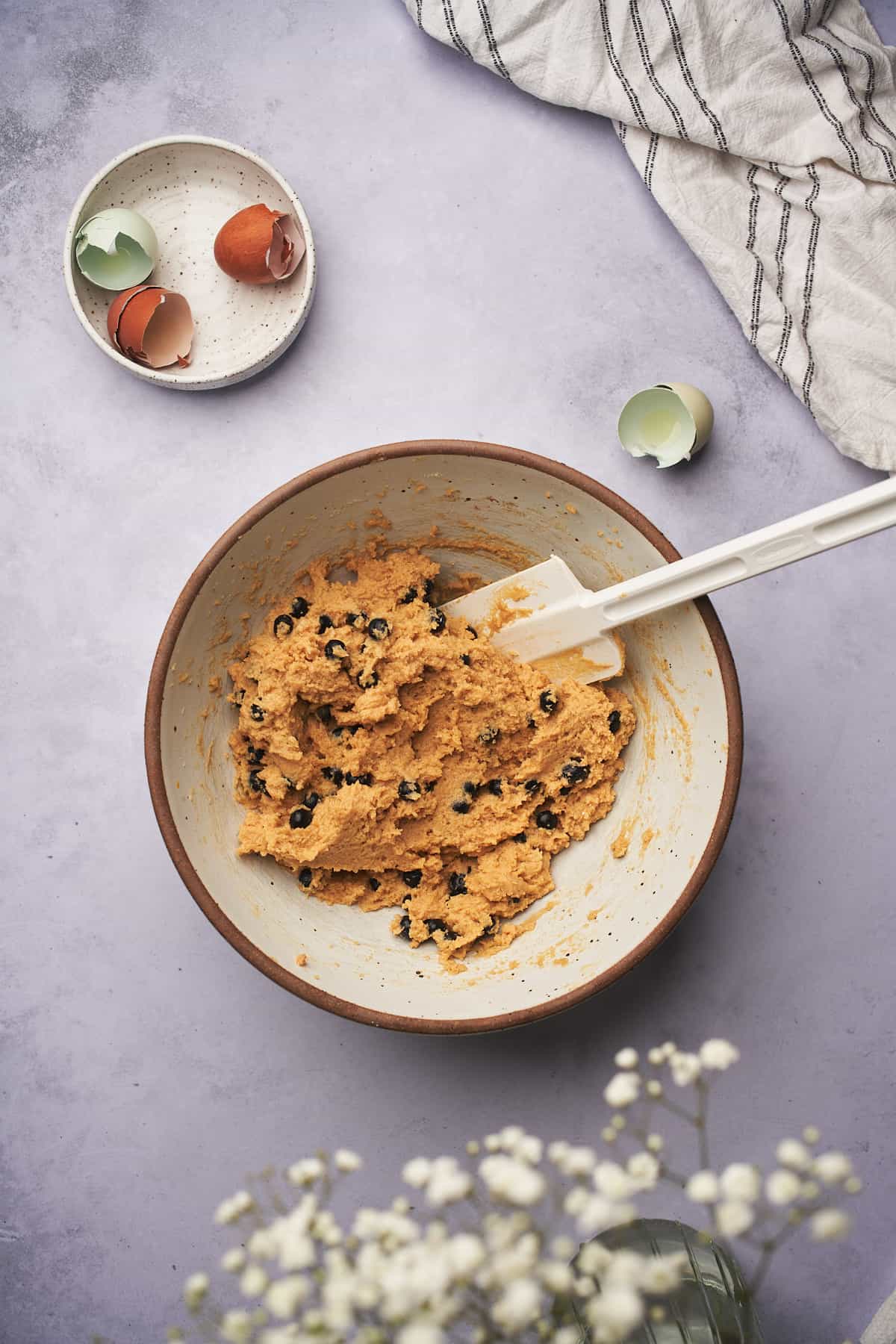 keto blueberry muffin batter in a large mixing bowl. 