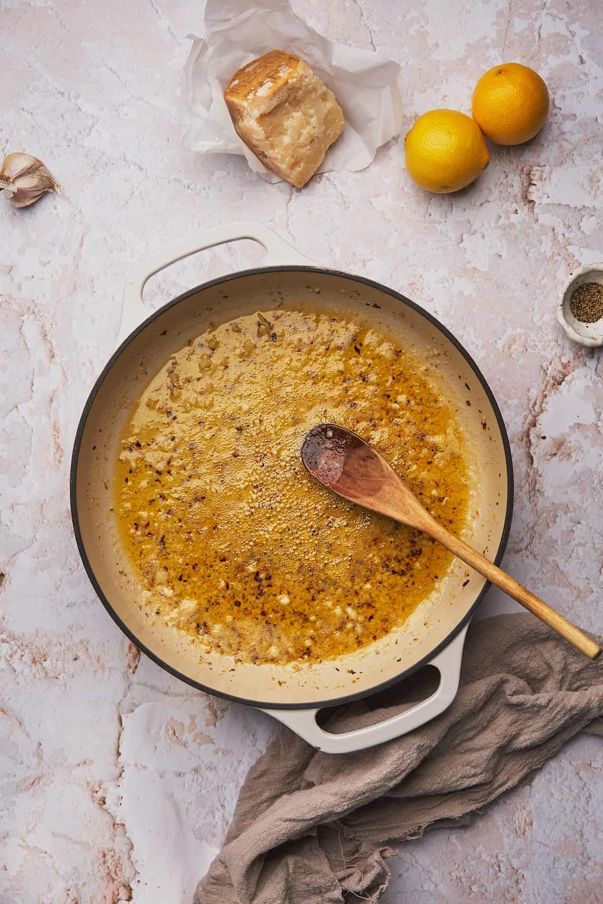 cooking garlic in butter and olive oil in an enameled cast iron skillet, and stirring with a wooden spoon. 