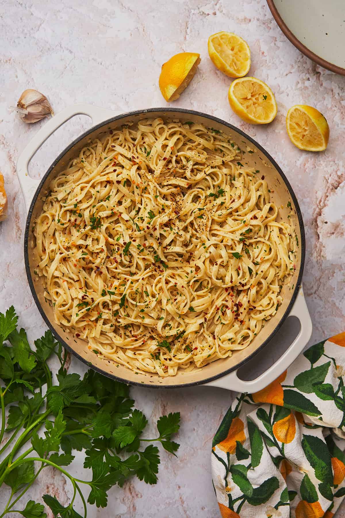 lemon garlic pasta with parmesan and fresh parsley in a skillet. 