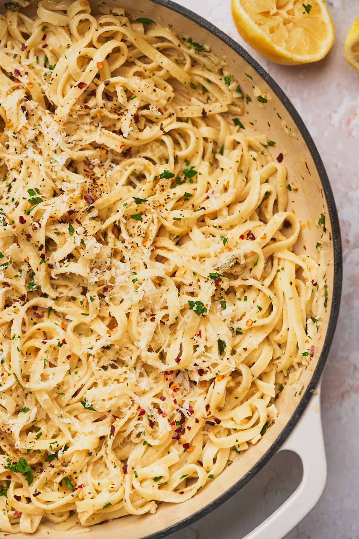 close up shot of pasta in a white enameled cast iron skillet. 