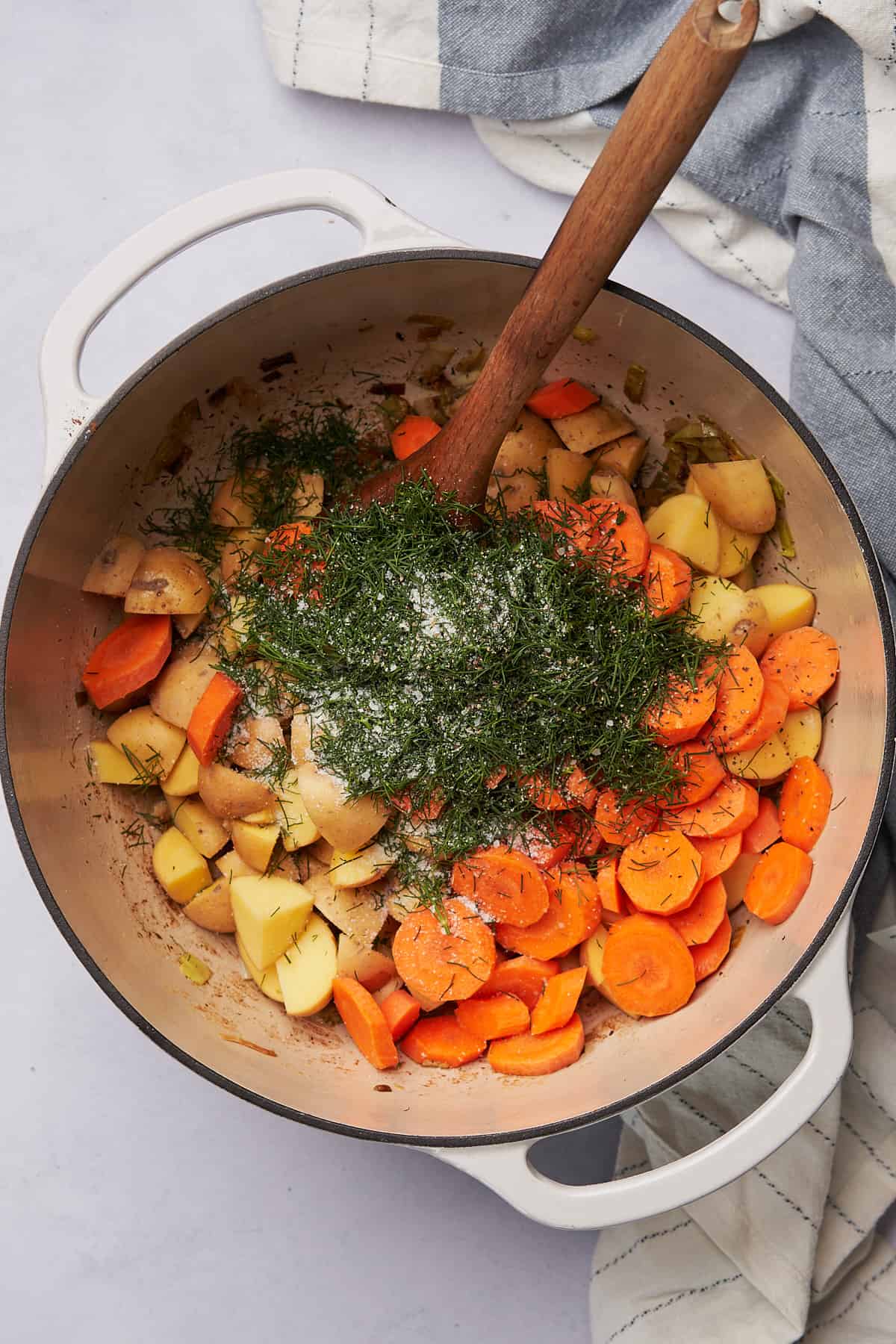 fresh dill, carrots, and potatoes in a dutch oven with salt. 