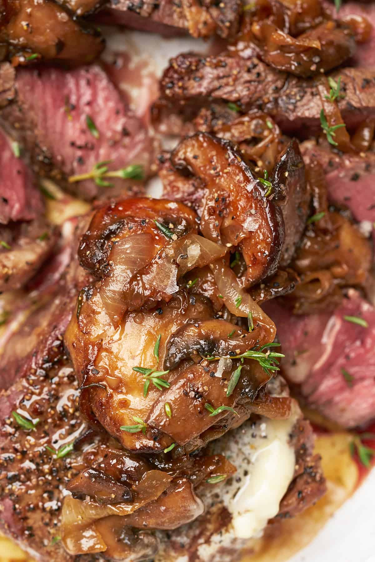 caramelized onions and mushrooms overtop of a perfectly cooked steak. 