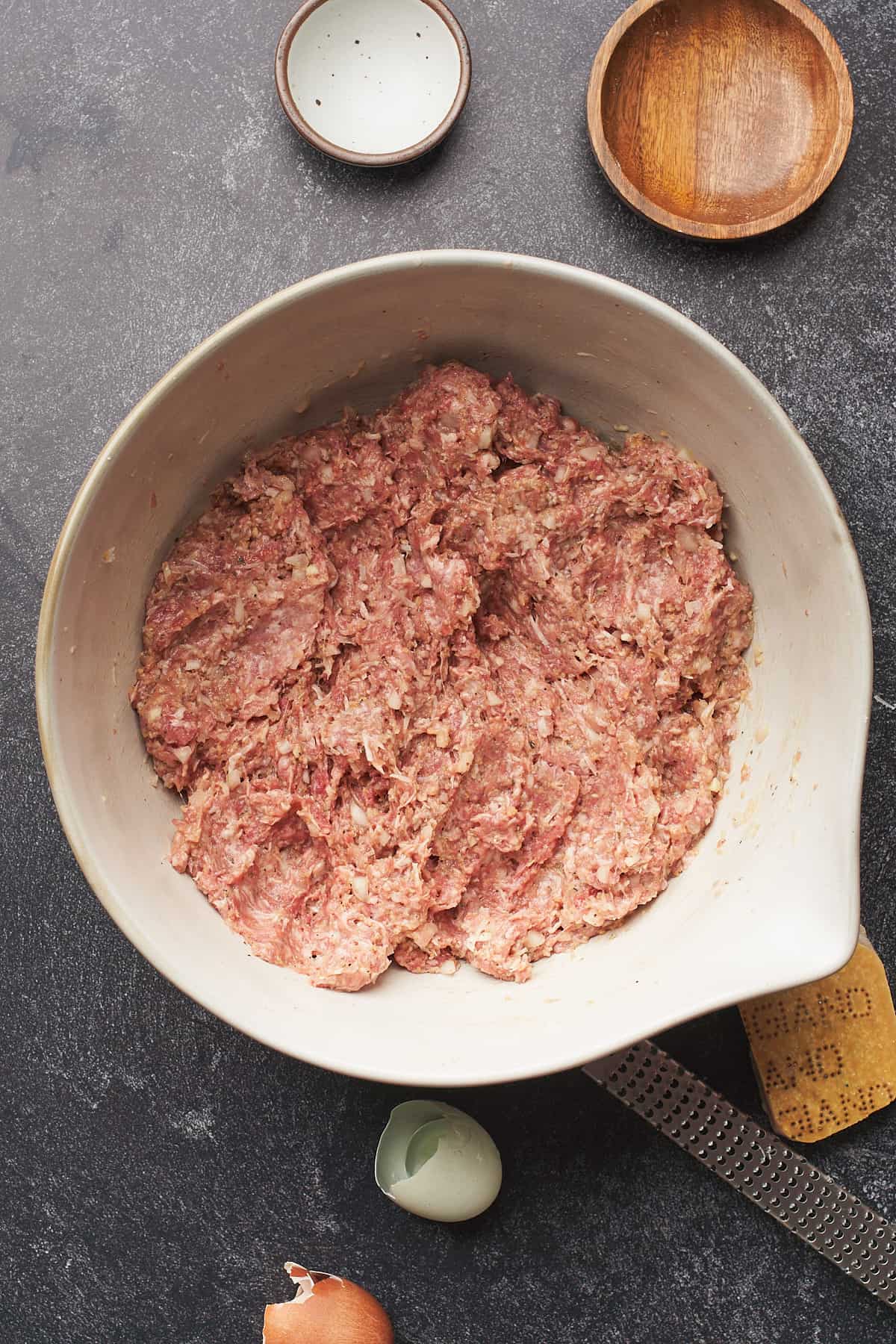 raw meatball mixture in a large mixing bowl.
