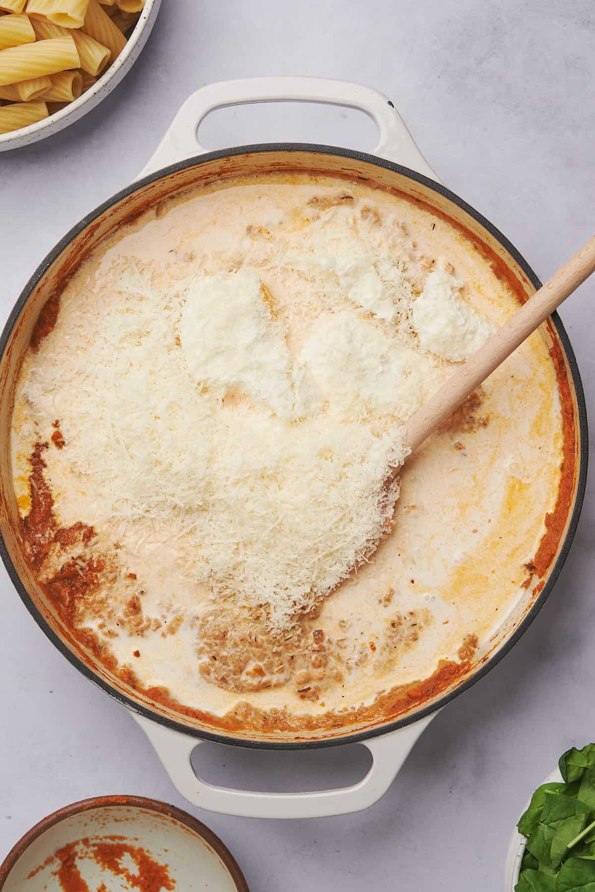 heavy cream, ricotta cheese, and parmesan in a skillet with pumpkin puree and seasonings. 