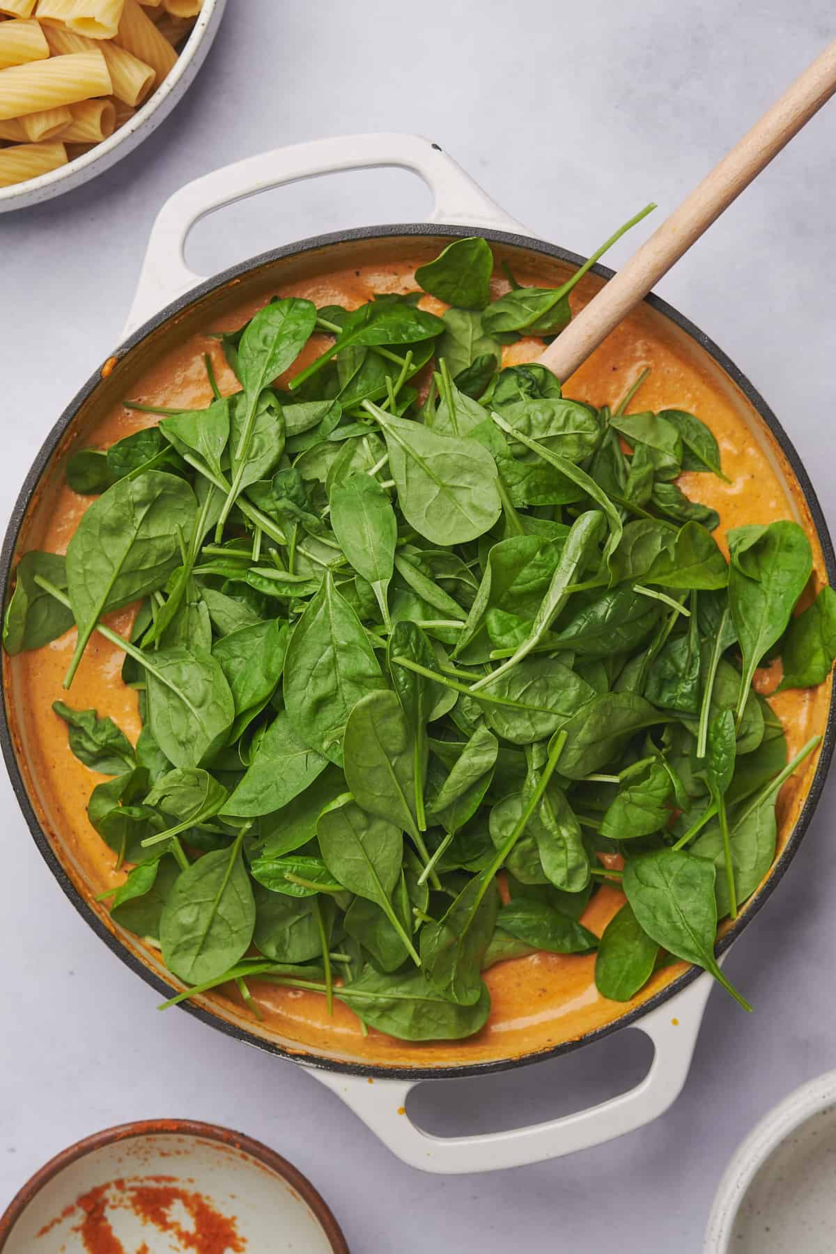fresh spinach added to pumpkin sauce in a large skillet. 