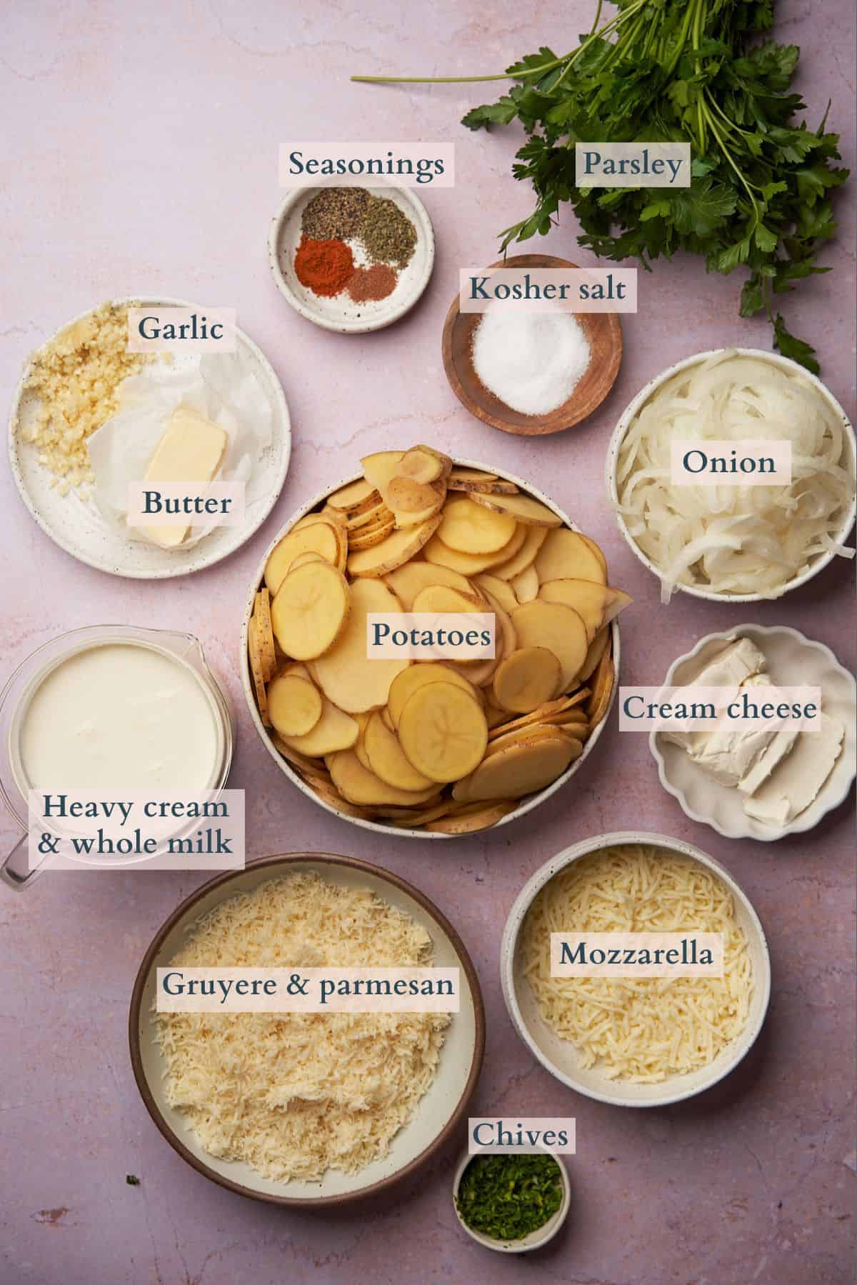 ingredients to make gluten free scalloped potatoes laid out in bowls with text overlaying to denote each ingredient. 