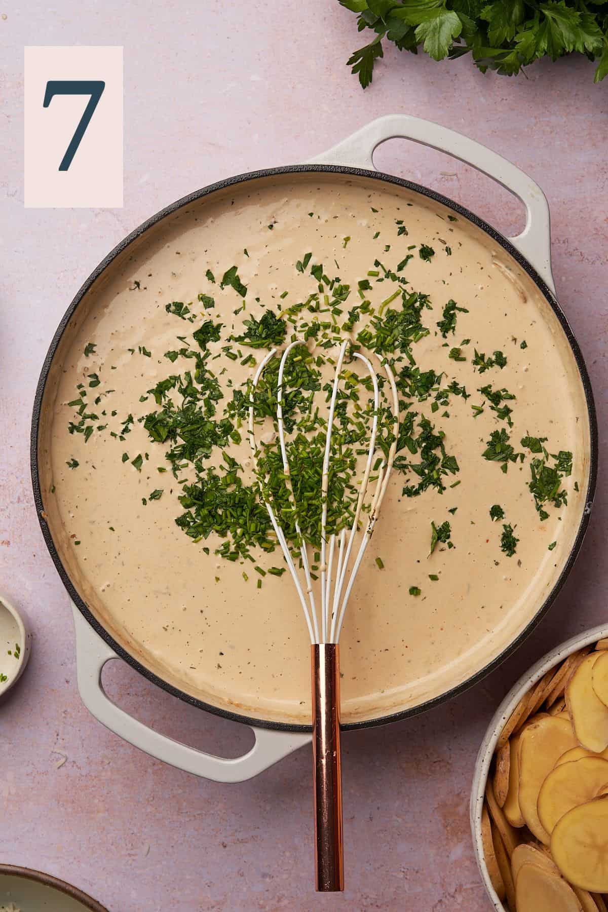 cheese sauce in a skillet with spices and fresh parsley. 