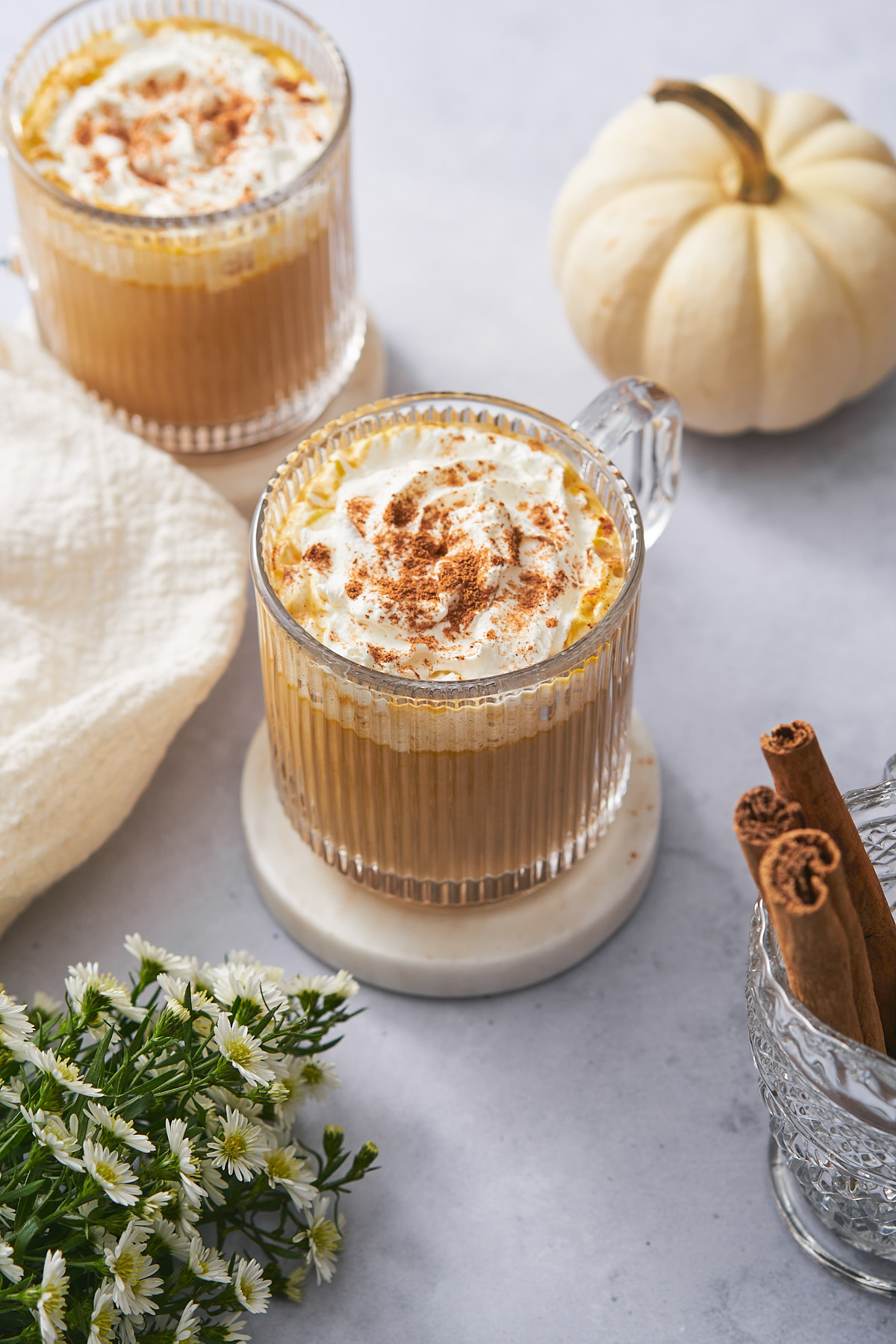 keto pumpkin spice latte topped with whipped cream, and ground cinnamon. 