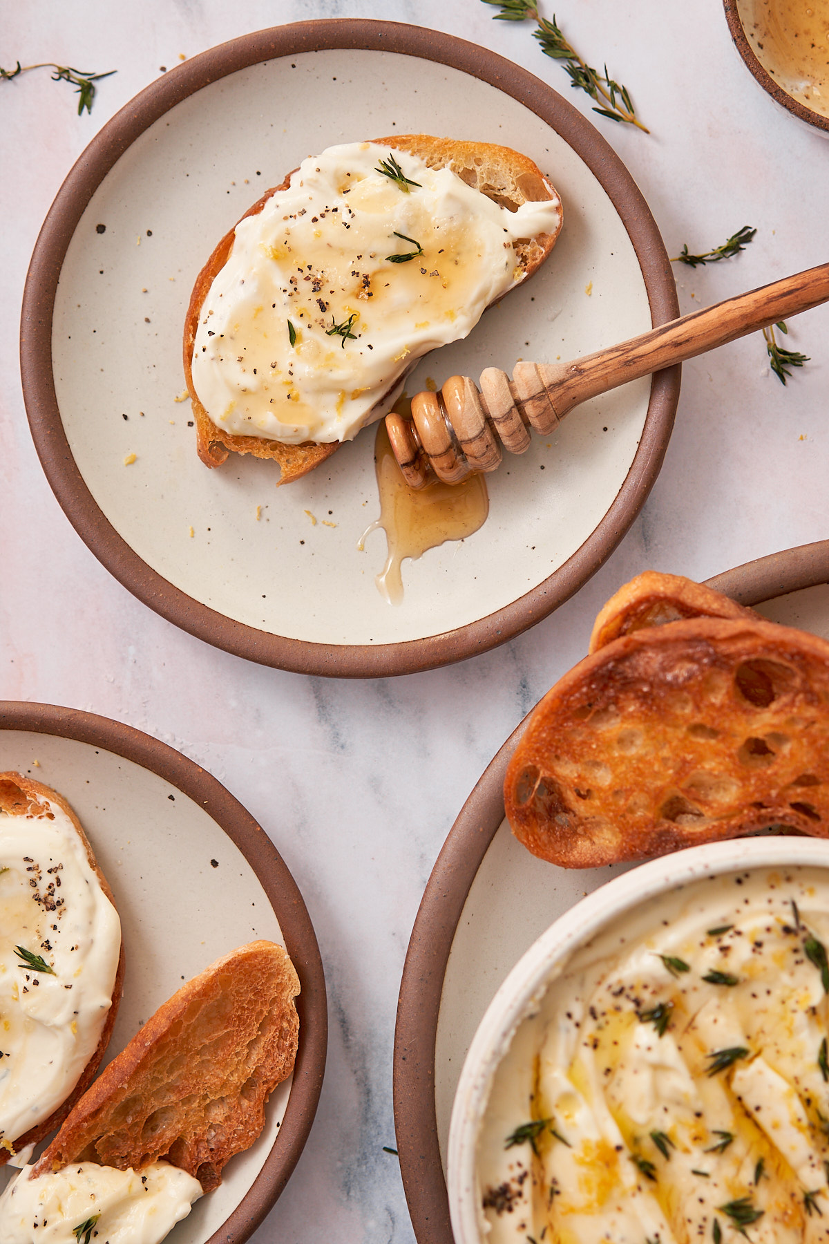 crispy toast topped with whipped ricotta, and a drizzle of honey, with flaky sea salt, and fresh thyme.