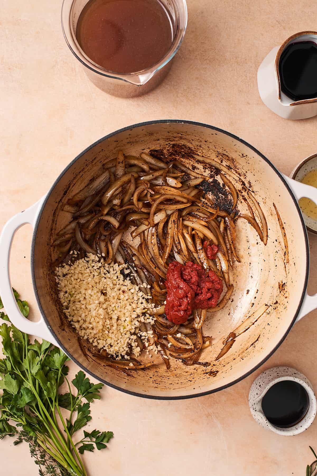 garlic, onion, and tomato paste in an enameled dutch oven.