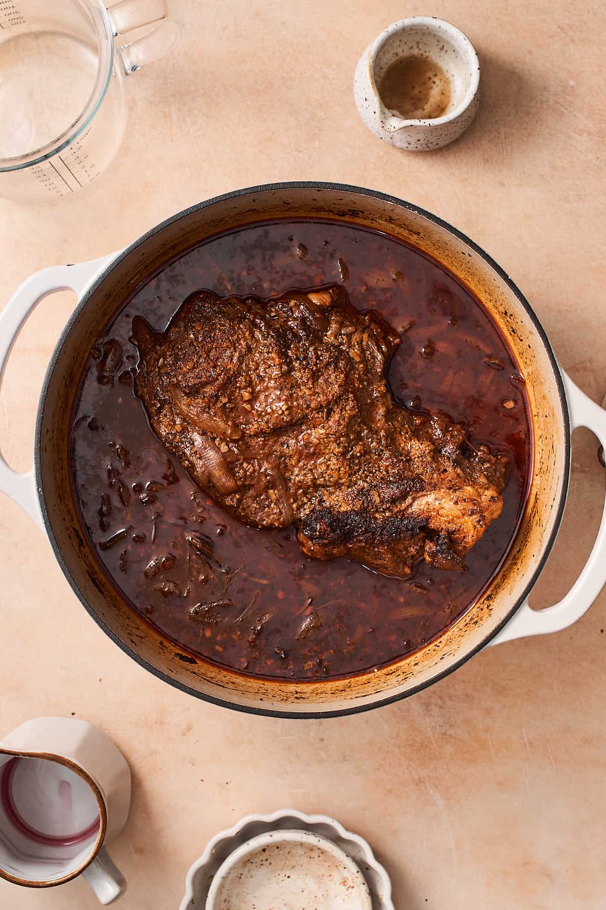 chuck roast cooked in an enameled dutch oven.
