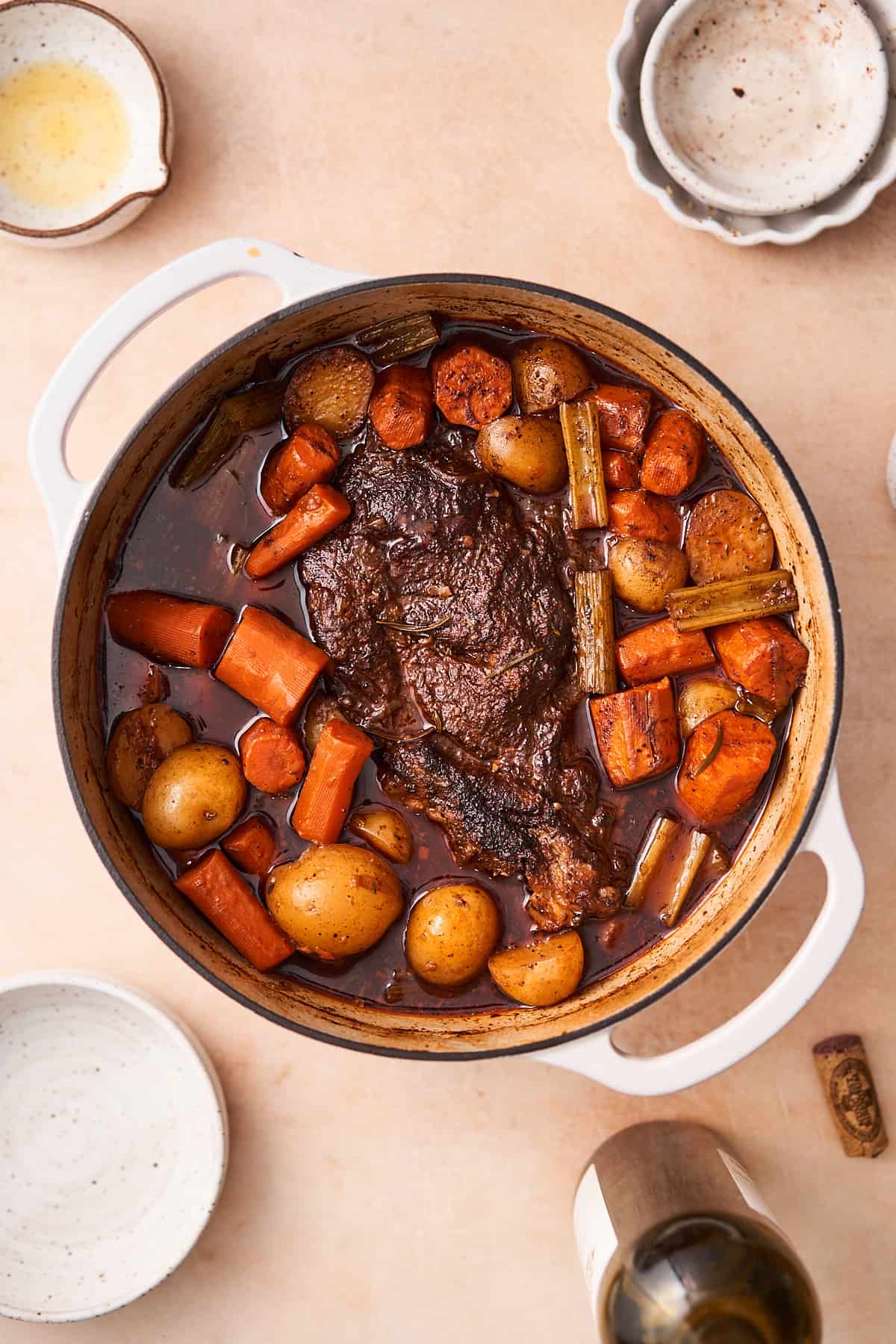 Cooked beef pot roast with potatoes, carrots, and celery.